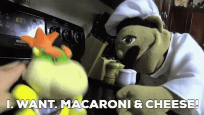 Two Stuffed Animals Standing Next To Each Other With The Words " I Want Macaroni & Cheese " On The Bottom GIF