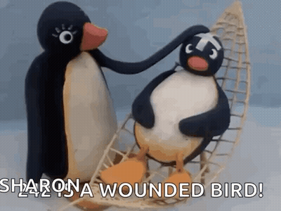Two Stuffed Penguins in Canoe Petting Head