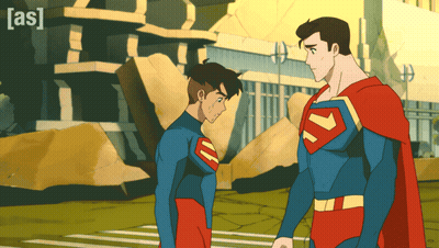 Two Superheroes Standing With Building Saying As GIF