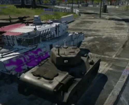 Two Tanks Parked Side By Side With Purple Paint GIF
