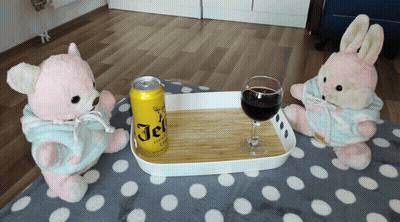 Two Teddy Bears Are Sitting Next To A Tray With A Can Of Jel On It GIF