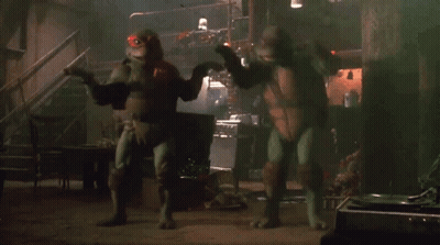 Two Teenage Mutant Ninja Turtles In Dark Room GIF