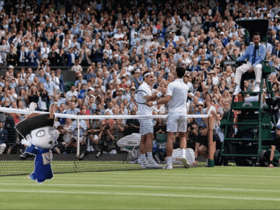 Two Tennis Players Are Shaking Hands On A Court With A Crowd Watching GIF