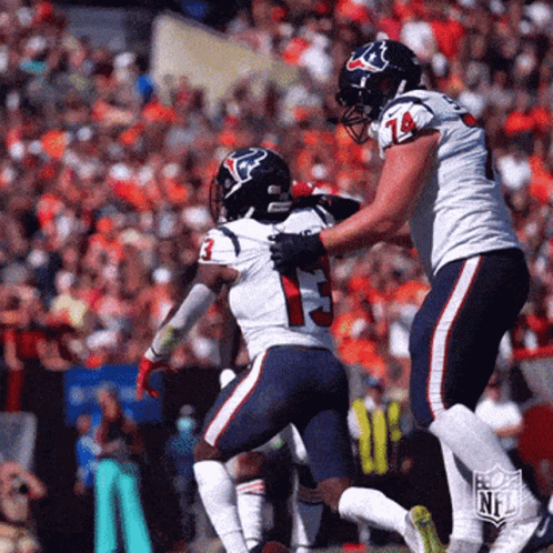 Two Texans Football Players Are Running On The Field GIF