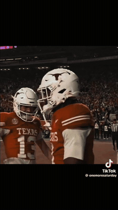 Two Texas Football Players Hugging GIF