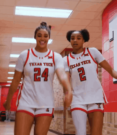Two Texas Tech Female Basketball Players Walking Down Hallway