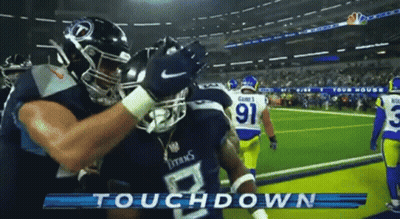 Two Titans Football Players Hugging On Field GIF