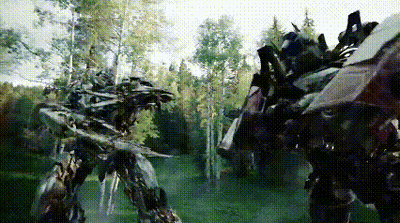 Two Transformers Are Fighting In A Forest With Trees In The Background GIF
