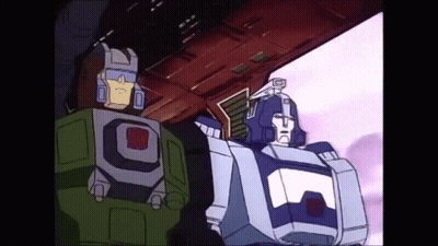 Two Transformers Standing Together GIF