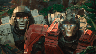 Two Transformers Standing With Glowing Eyes GIF