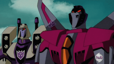 Two Transformers Standing With Hub Logo On Chests GIF