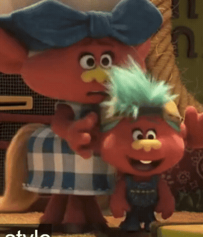 Two Trolls Are Standing Next To Each Other And One Has A Blue Bow On His Head GIF