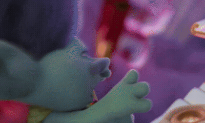 Two Trolls Are Standing Next To Each Other And One Has A Crown On His Head GIF