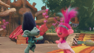 Two Trolls Dancing In Front Of A Sign That Says ' Trolls ' On It GIF