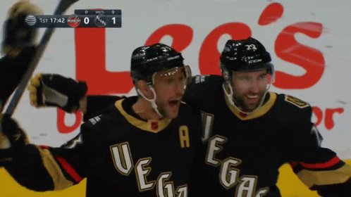 Two Vegas Hockey Players Celebrate A Goal In Front Of An Advertisement For Lee 'S GIF