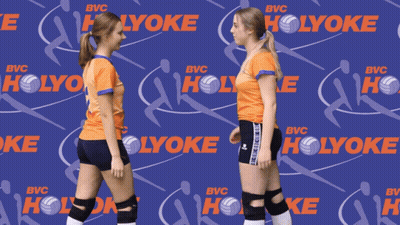Two Volleyball Players Holding Hands In Front Of A Holyoke Background GIF