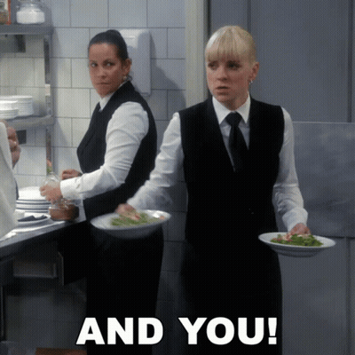 Two Waitresses Carrying Plates Of Food GIF