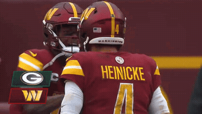 Two Washington Redskins Players Are Hugging Each Other During A Fox Nfl Game GIF