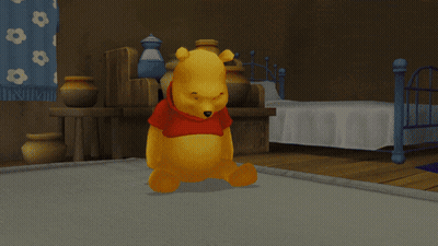 Two Winnie The Pooh Bears Are Standing Next To Each Other On A Bed GIF