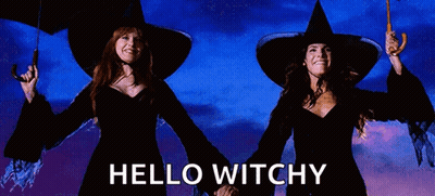 Two Witches Holding Umbrellas With The Words Hello Witchy Written Below Them GIF