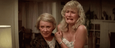 Two Women Are Crying In A Living Room . GIF