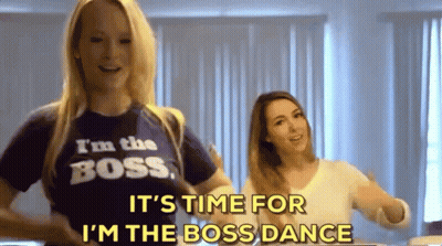 Two Women Are Dancing And One Of Them Is Wearing A T-Shirt That Says I 'M The Boss . GIF