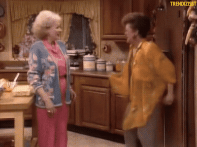 Two Women Are Dancing In A Kitchen With The Words Trendizisst Written Above Them GIF