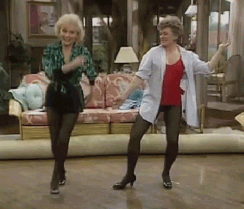 Two Women Are Dancing In A Living Room . GIF