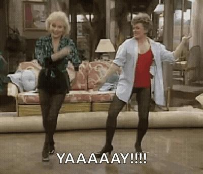 Two Women Are Dancing In A Living Room While Holding Hands . GIF