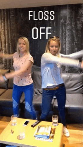 Two Women Are Dancing In Front Of A Couch With The Words Floss Off Written Above Them GIF