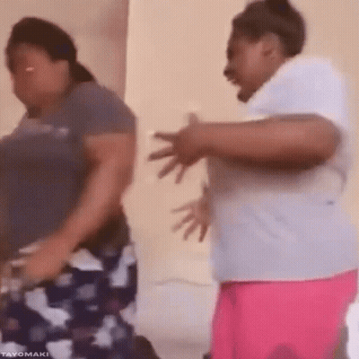 Two Women Are Dancing Together In A Room And One Of Them Is Laughing . GIF