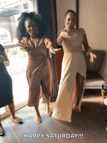 Two Women Are Dancing With The Words Happy Saturday Written Below Them GIF