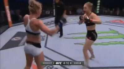 Two Women Are Fighting In A Boxing Ring With A Monster Energy Logo In The Background . GIF