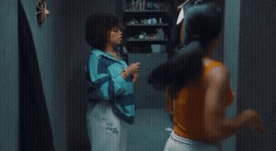 Two Women Are Having An Argument In A Room And One Of Them Is Wearing A Shirt That Says Tsl On It GIF