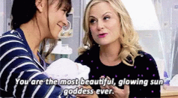Two Women Are Holding A Baby And One Of Them Says You Are The Most Beautiful Glowing Sun Goddess Ever . GIF