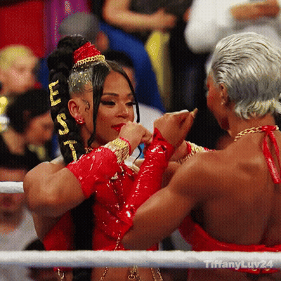 Two Women Are Hugging In A Boxing Ring With Tiffanyluv24 Written On The Bottom Right GIF