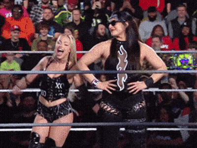 Two Women Are In A Wrestling Ring And One Has The Letter X On Her Shirt GIF