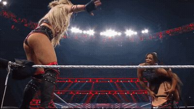 Two Women Are In A Wrestling Ring With The Word Raw On The Bottom GIF