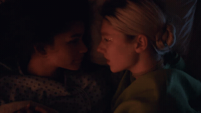 Two Women Are Laying Next To Each Other And One Has A Star On Her Face GIF