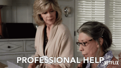 Two Women Are Looking At A Piece Of Paper And The Words Professional Help Are Visible GIF