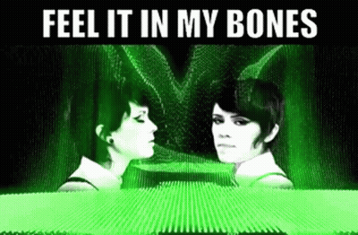 Two Women Are Looking At Each Other With The Words Feel It In My Bones Above Them GIF