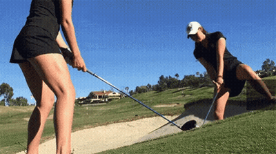 Two Women Are Playing Golf On A Golf Course And One Is Kneeling On The Green GIF