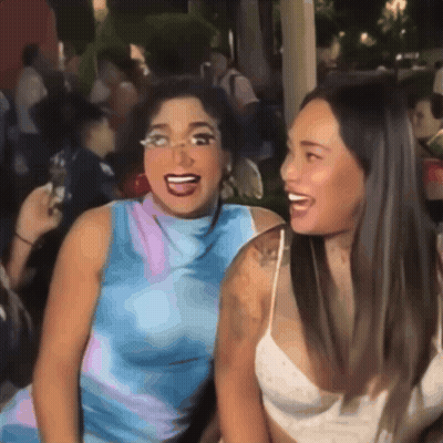 Two Women Are Posing For A Picture And One Has Glasses On GIF