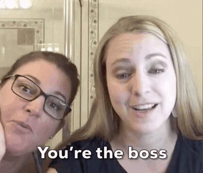 Two Women Are Posing For A Picture And One Of Them Says You 'Re The Boss GIF
