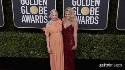 Two Women Are Posing For A Picture On The Red Carpet For The Golden Globe Awards GIF