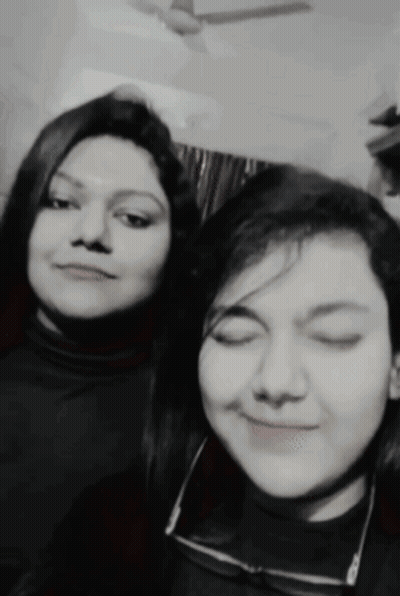Two Women Are Posing For A Picture Together With Their Eyes Closed GIF
