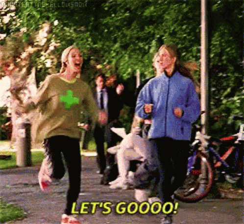 Two Women Are Running Down A Path And One Of Them Is Saying Let 'S Goooo ! GIF