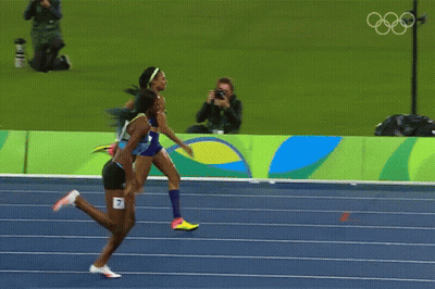 Two Women Are Running On A Track That Says Rio 2014 GIF