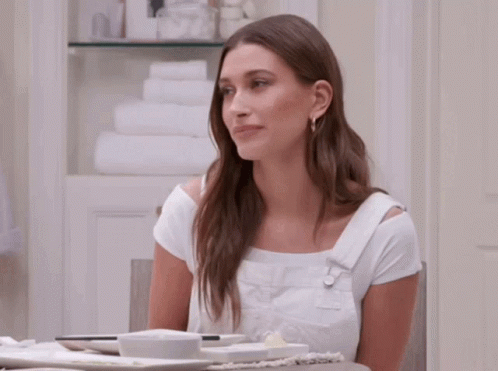 Two Women Are Sitting At A Table And One Is Wearing Adidas Sneakers GIF