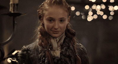 Two Women Are Sitting At A Table With A Cake In Front Of Them GIF